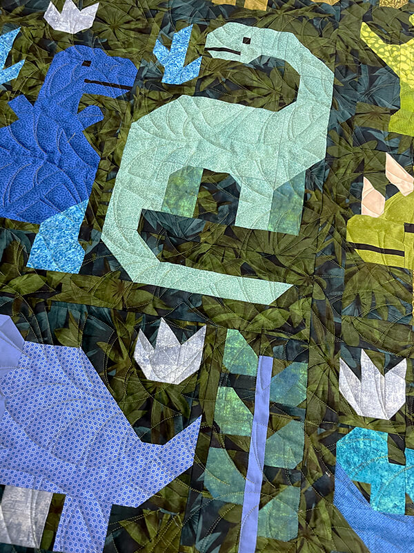 Close-up ona kids dinosaur quilt